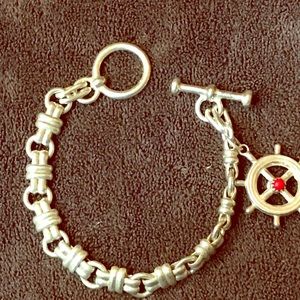 Silver bracelet with silver and coral charm.